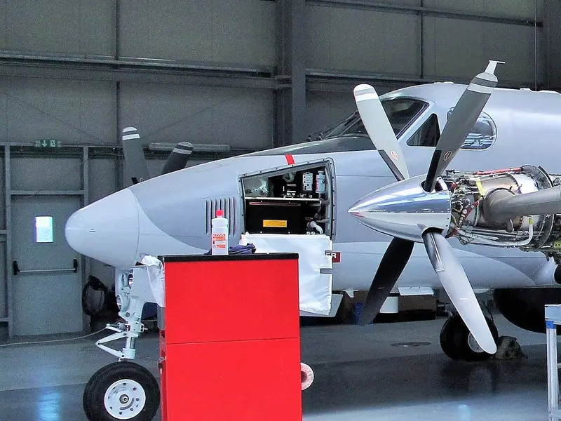 Turboprop aircraft parked in a maintenance hangar