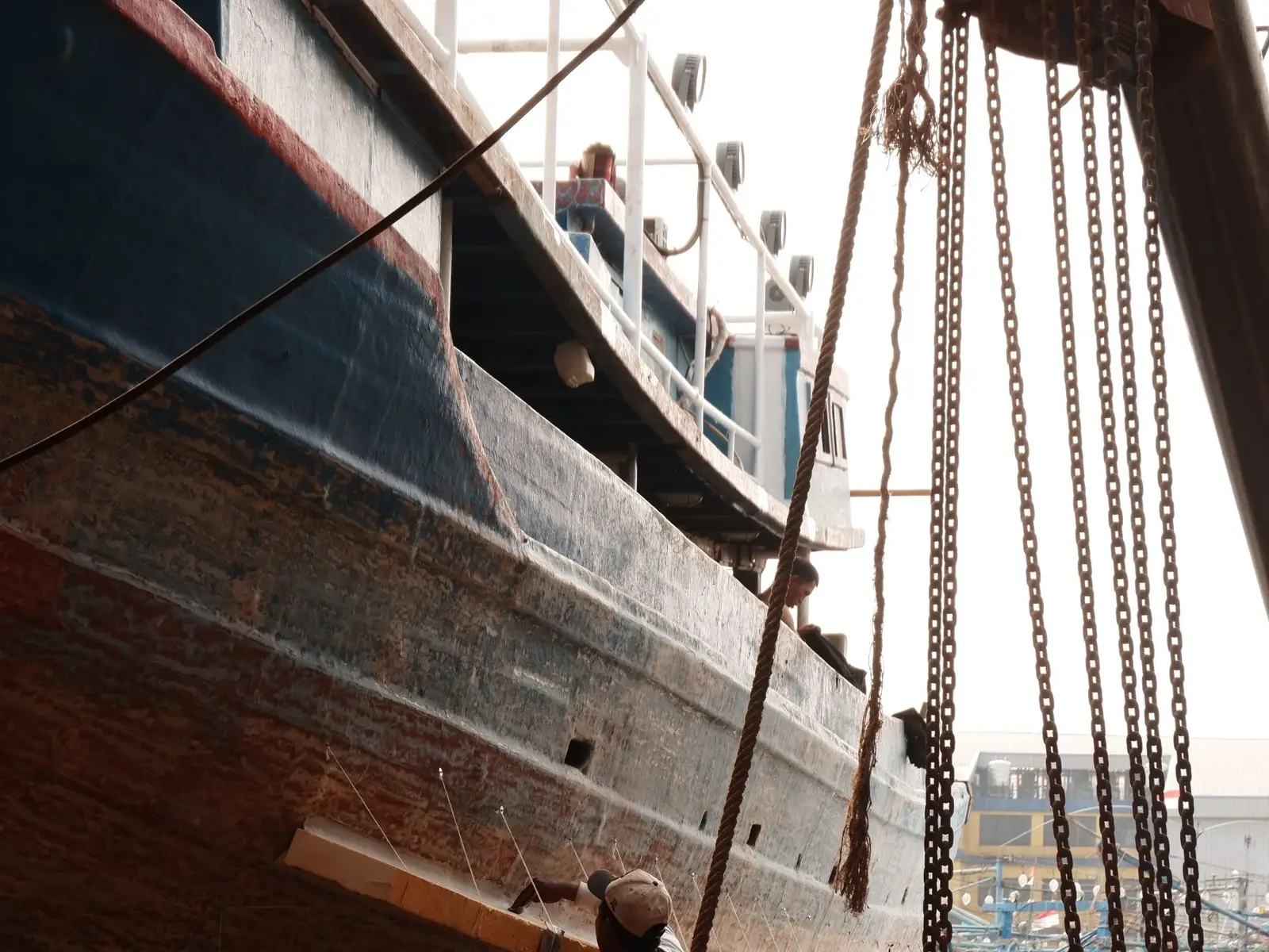 Hull of a large ship under repair at a shipyard